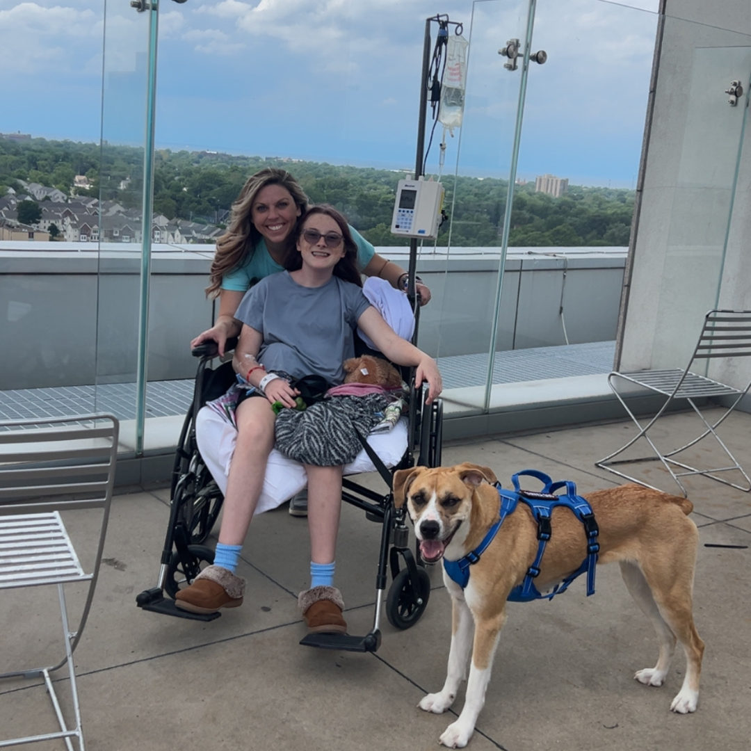 mom, daughter and dog on rooftop