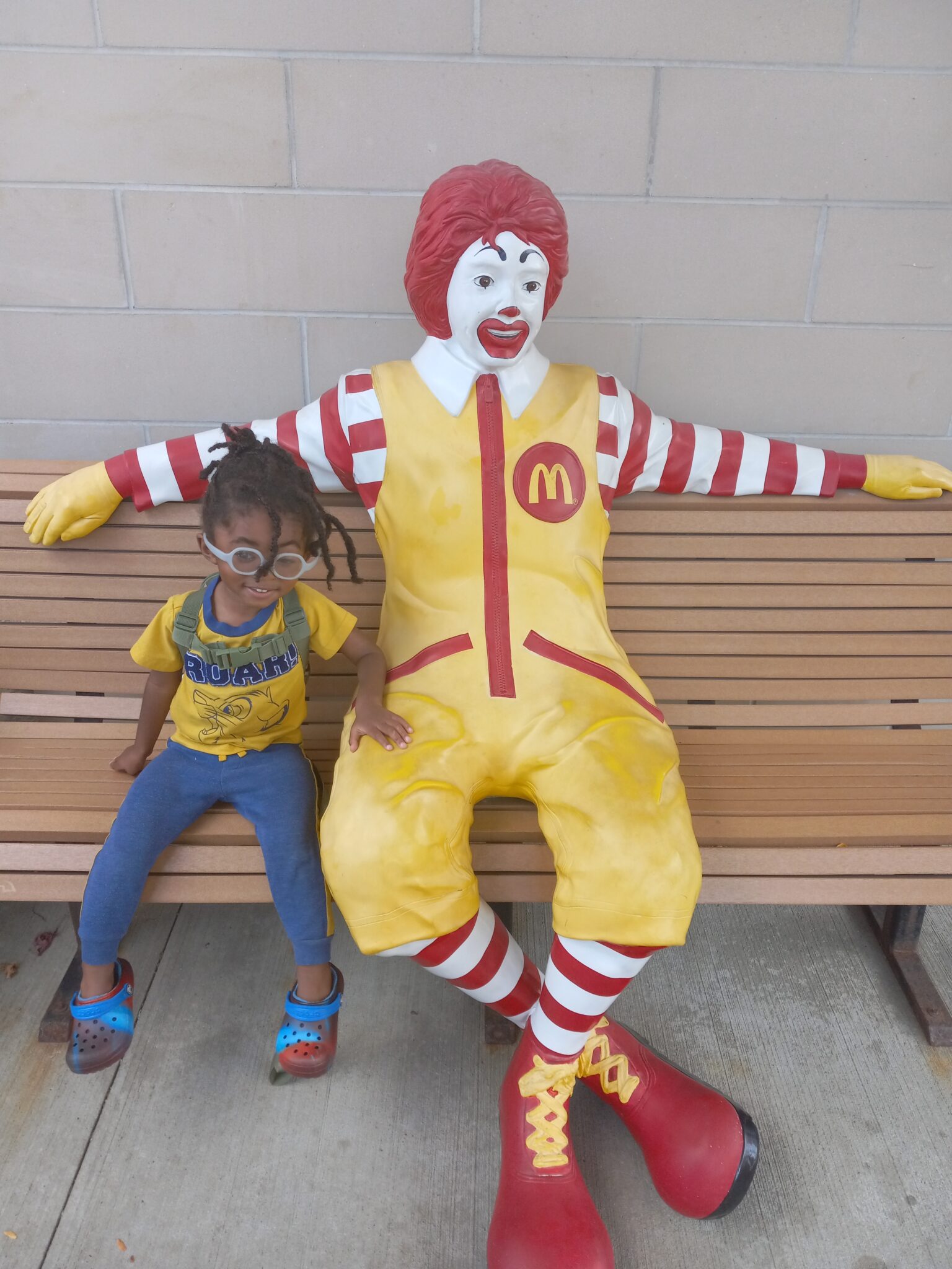 little boy on bench with ronald mcdonald