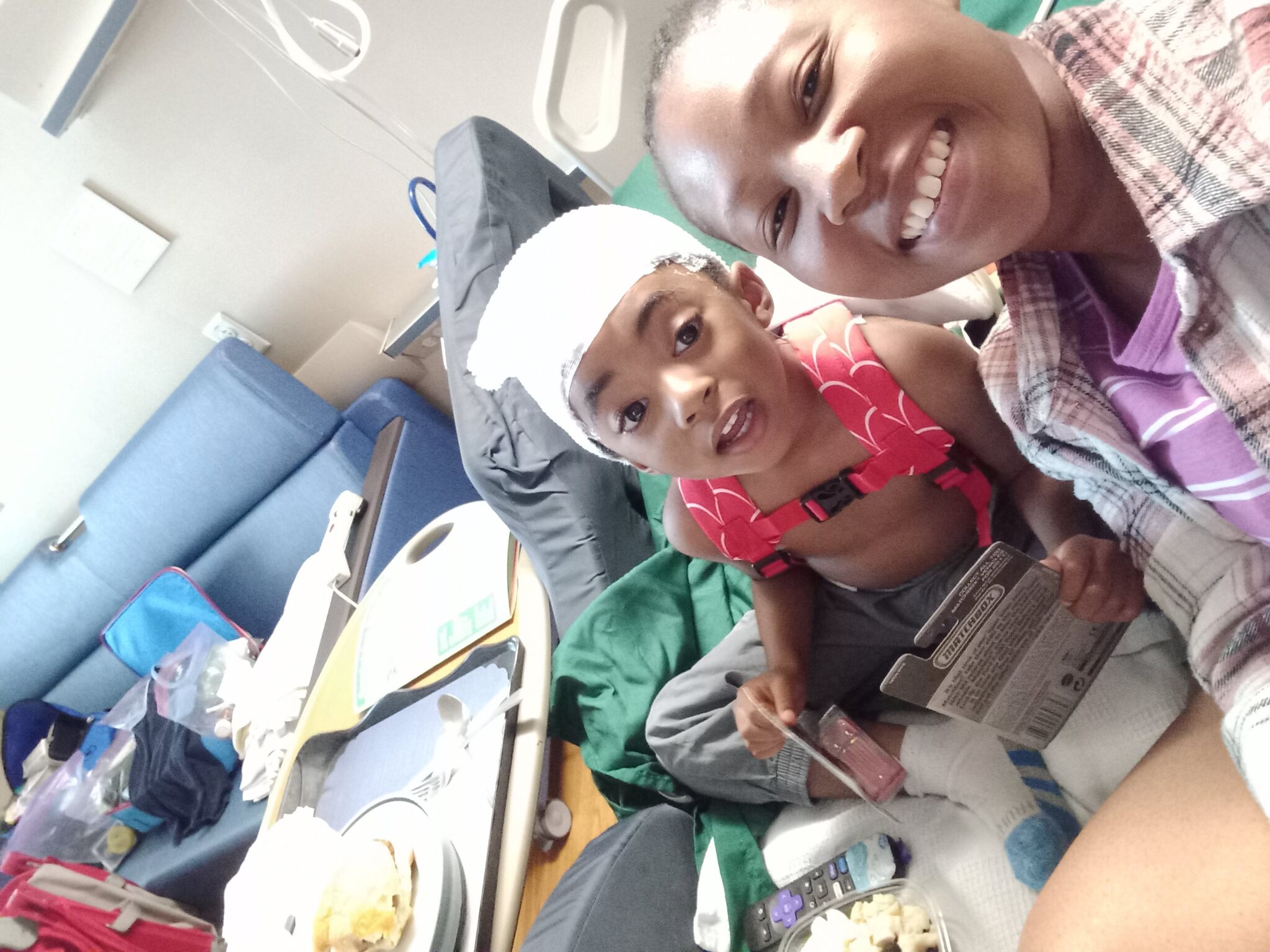 mom and son in hospital receiving treatment.