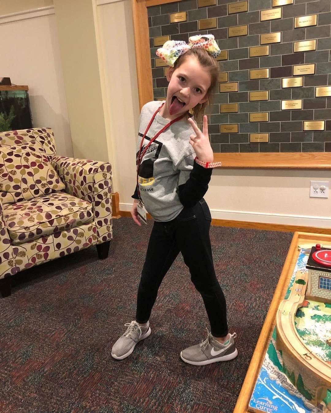 Posing with a peace sign in the front lobby.