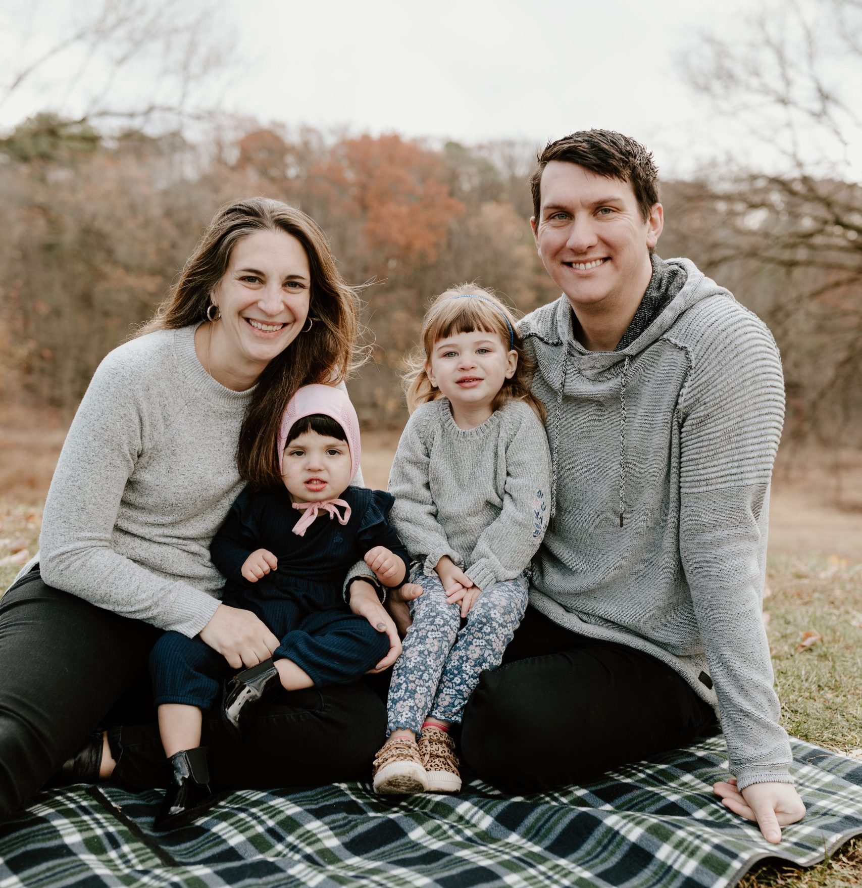 Mom, Dad and two baby girls in family photo