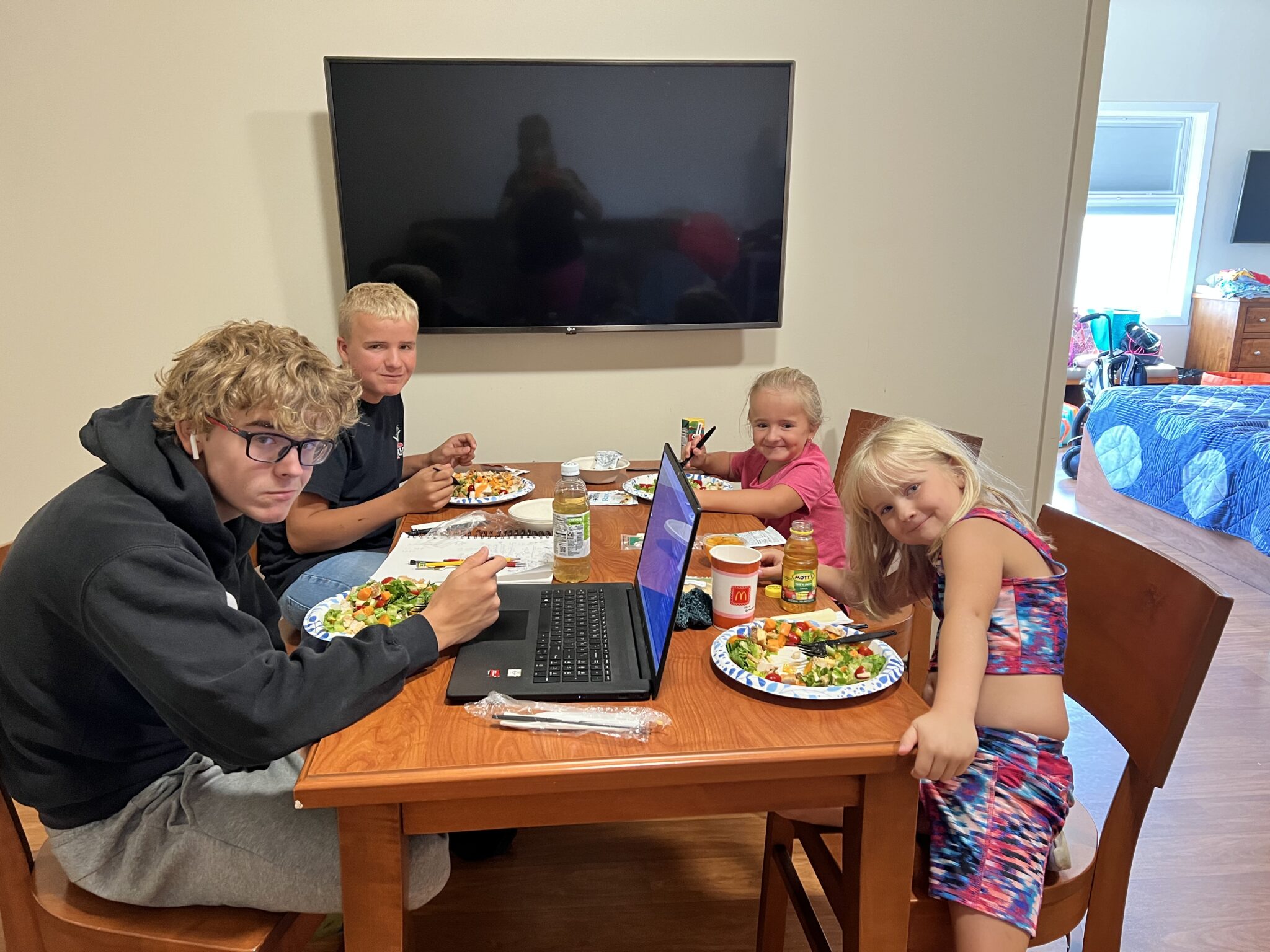 Picture of a family eating at a wooden table