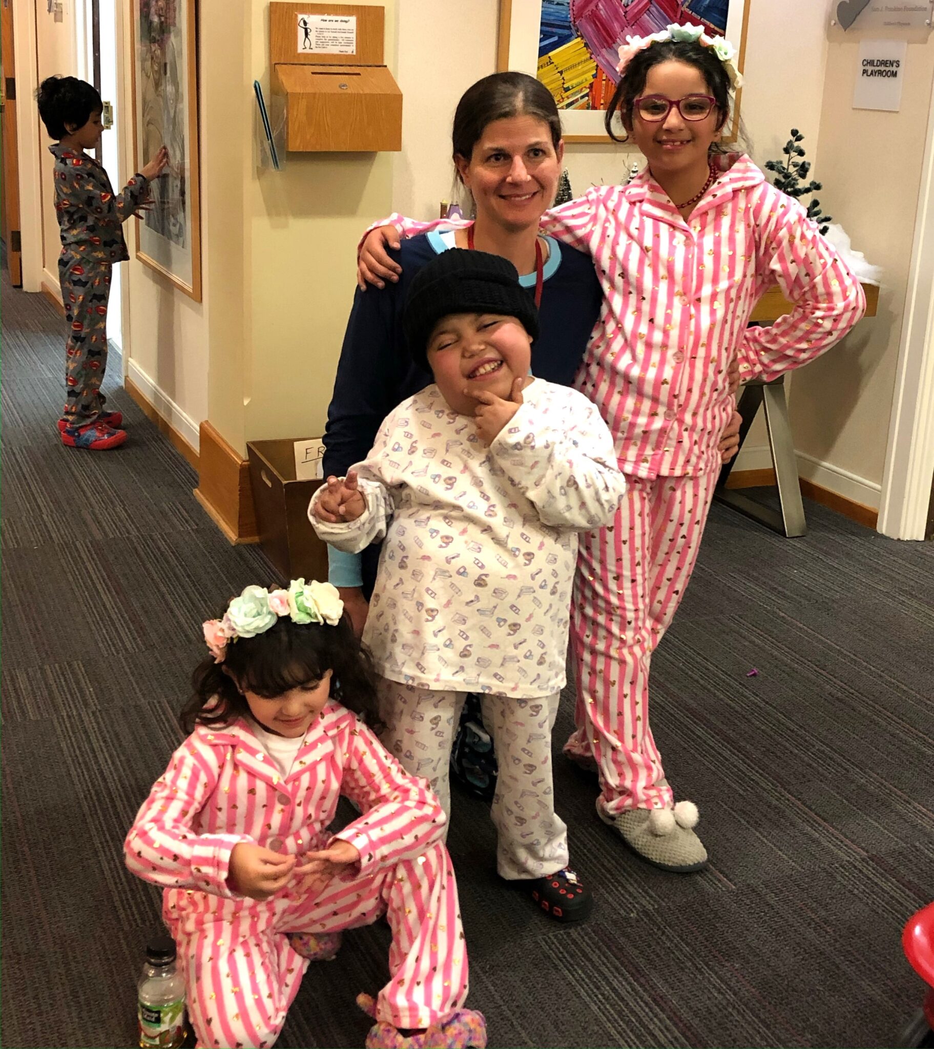 Woman with three children posing in pajamas