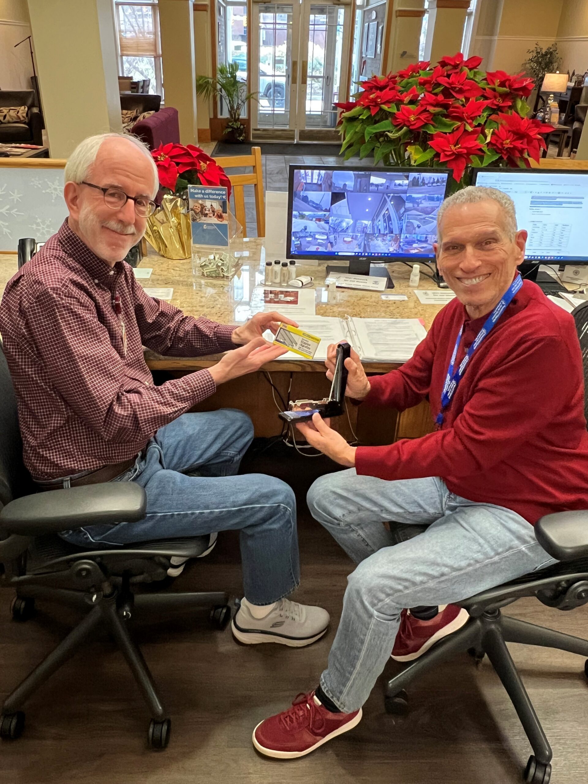 Two volunteers working together at a Ronald McDonald House front desk
