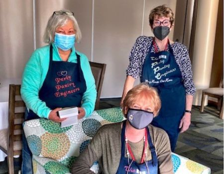three women with masks on posing for photo