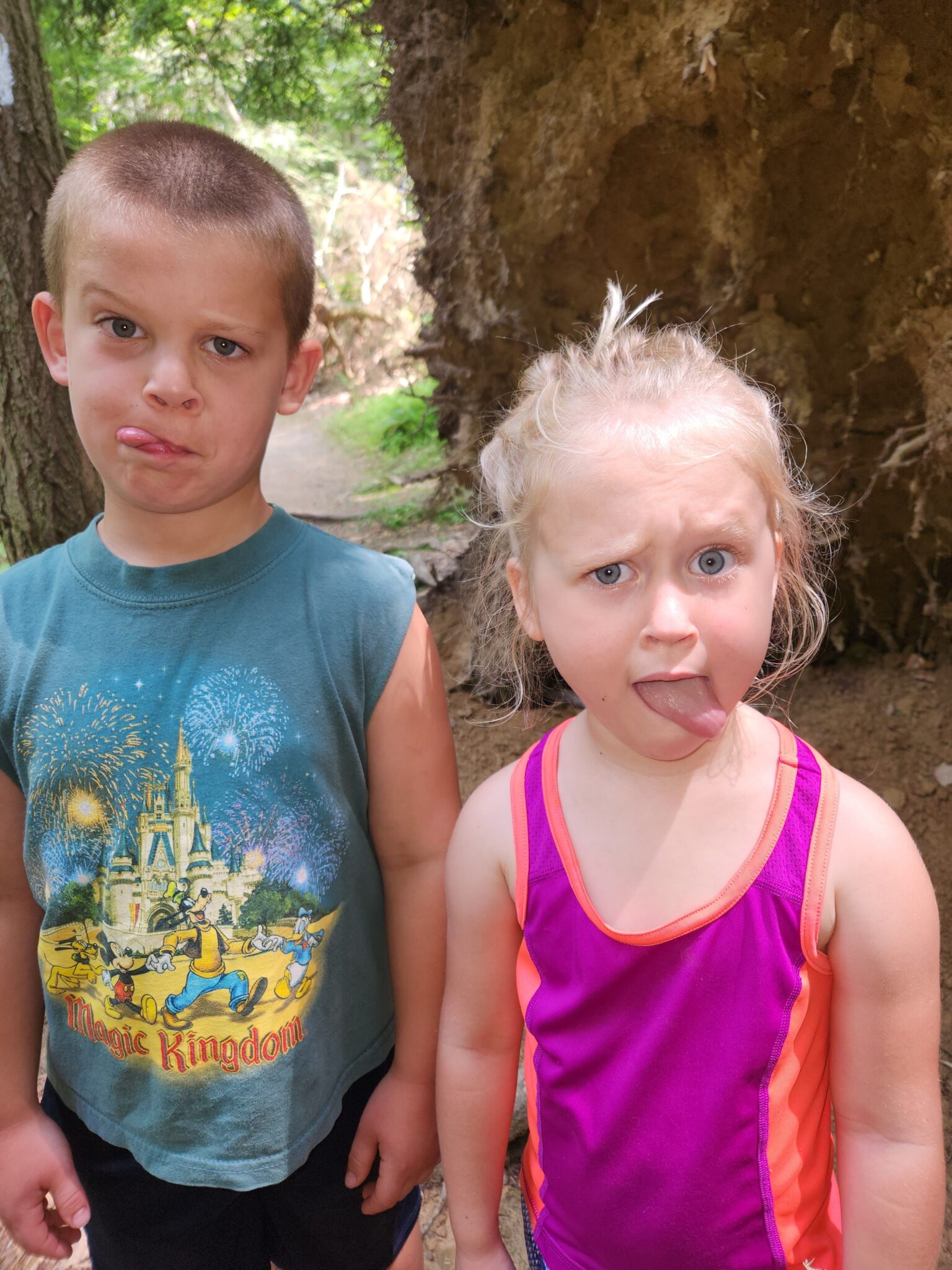 Wyatt and Evie Brown, making faces at the camera. it's summer outside