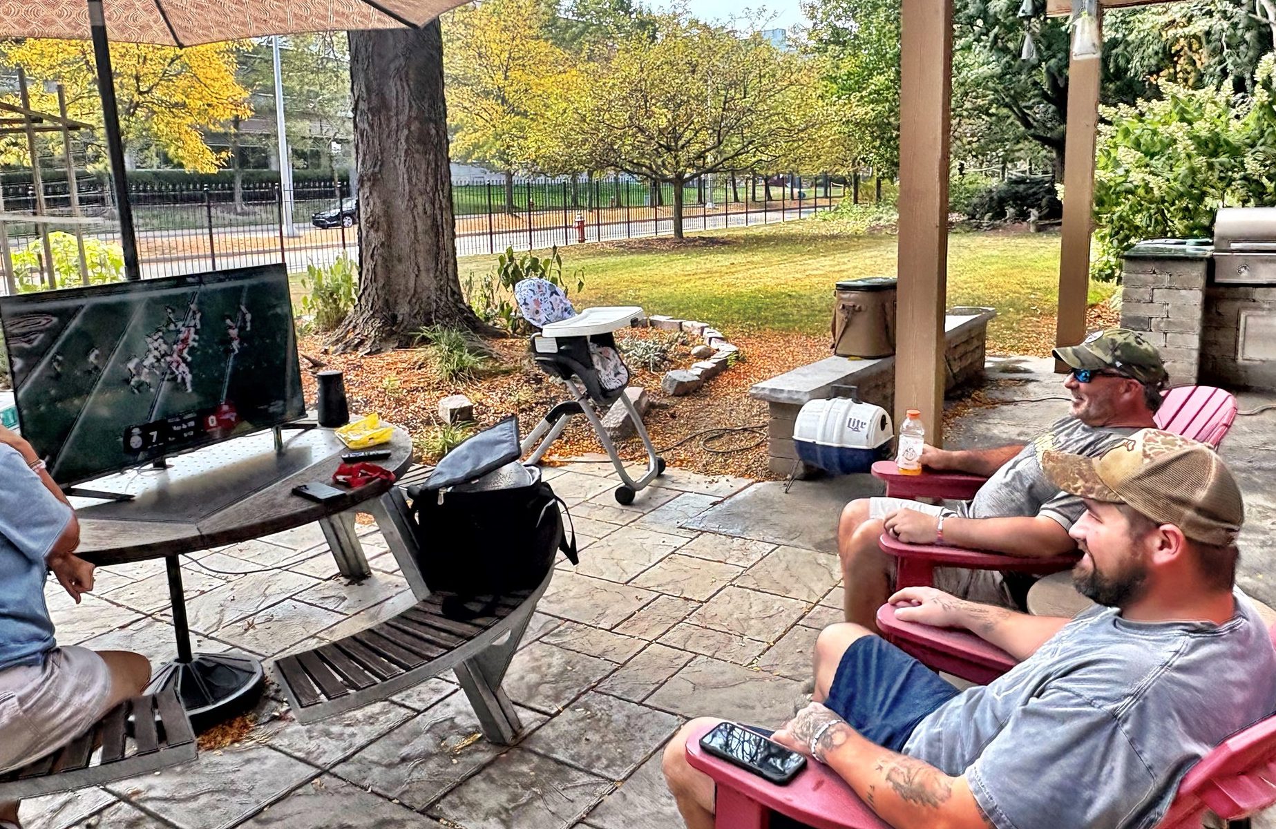 guys watching football on patio
